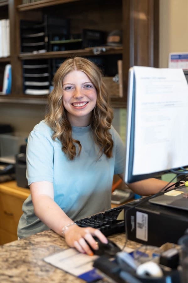 Lynzie at the front counter at Newcastle Tag Agency